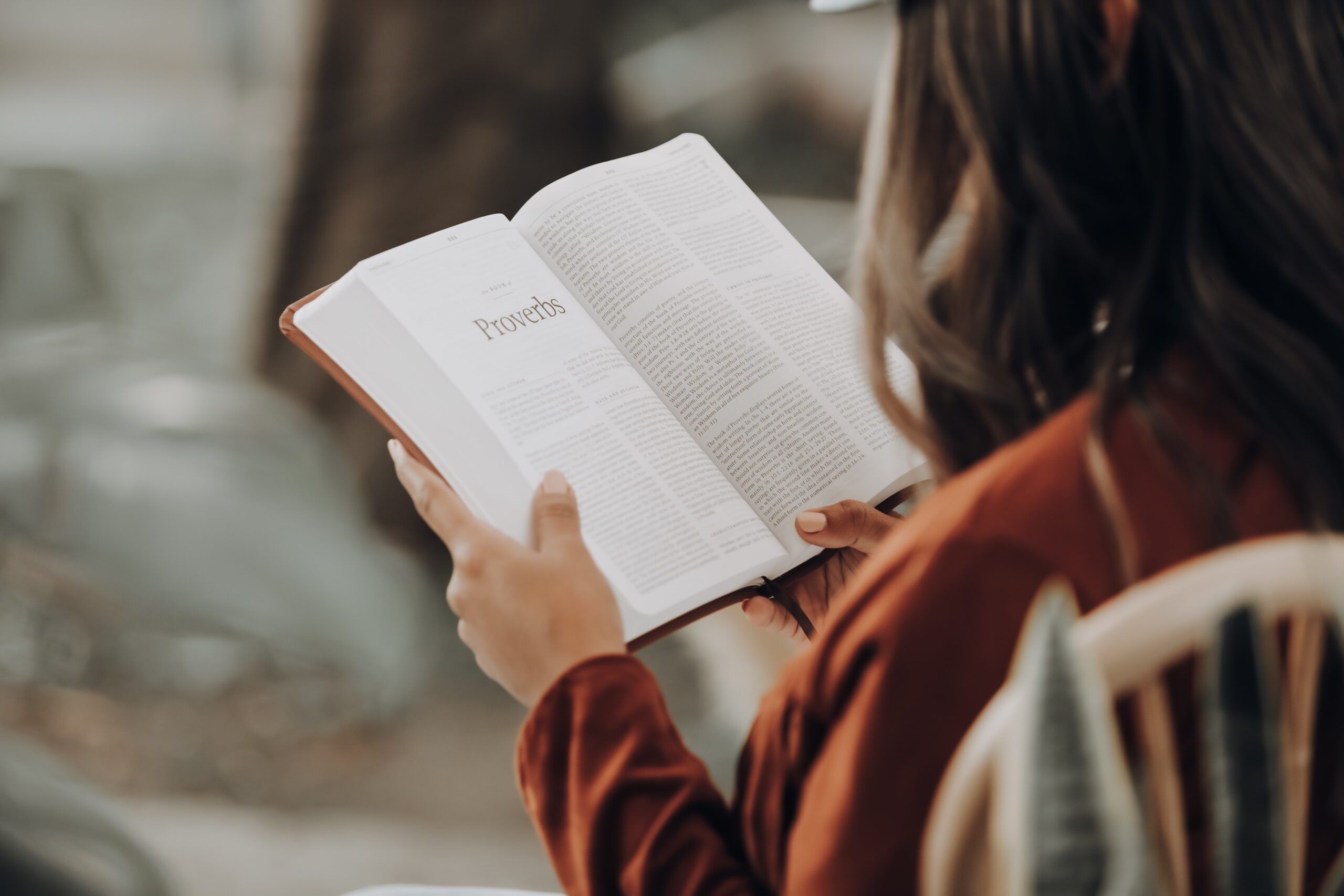 A Woman Reading Daily Biblical Affirmations for Women